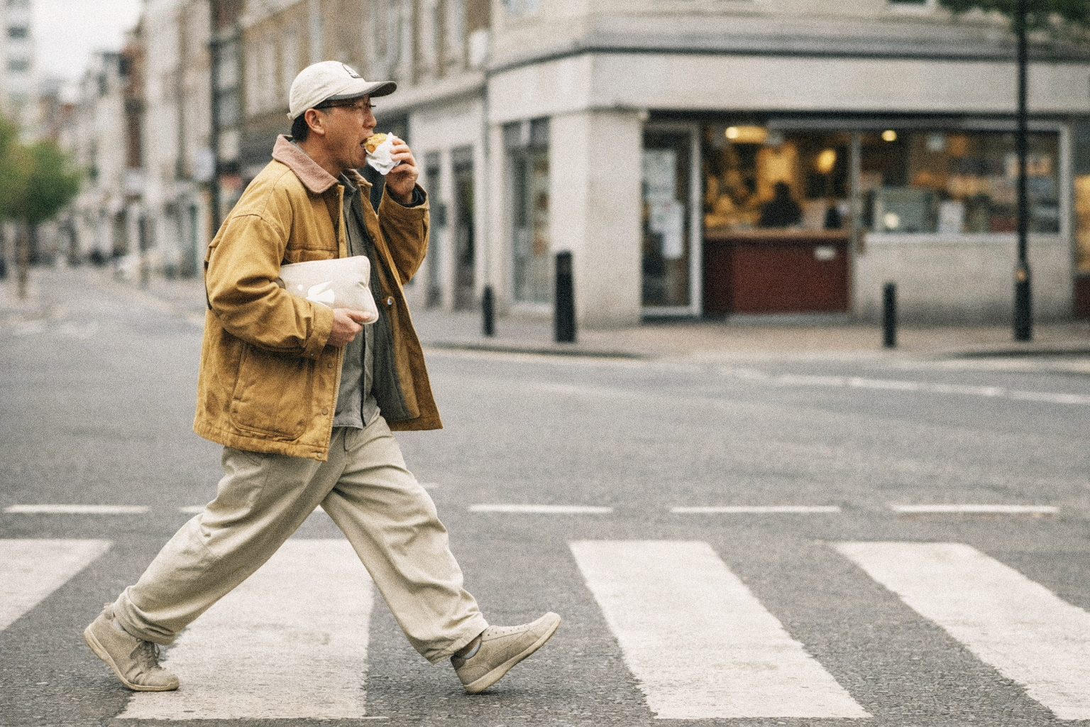 Shopper carrying a parcel across a London street